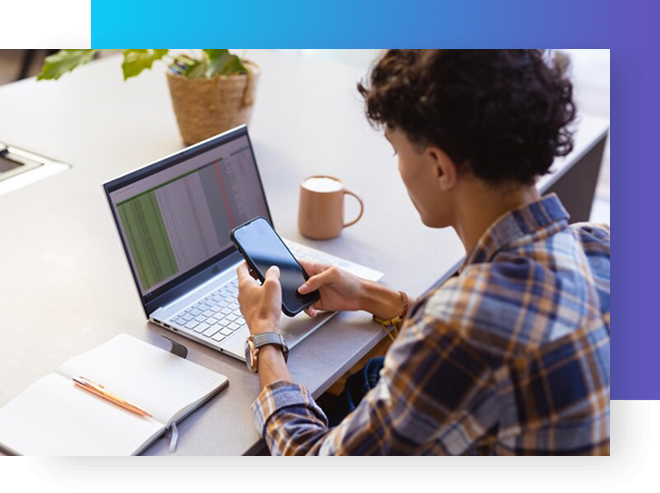 Professional using phone and laptop