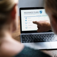 Person browsing insurance plans Person browsing insurance plans